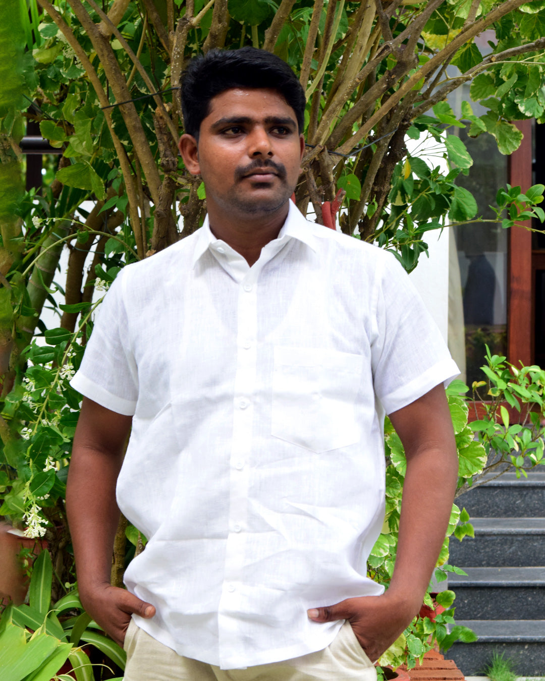 men's model standing, wearing a white linen half sleeve shirt