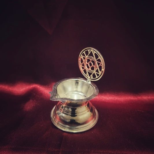 silver oil lamp with the mother and sri aurobindo's symbol of sri aurobindo ashram pondicherry marketed by aura store