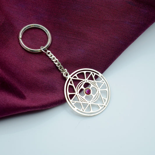 universal symbol pure silver key chain with pink stone given by the mother of sri aurobindo ashram pondicherry marketed by aura store