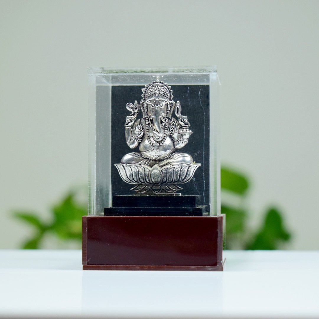 lord ganes silver idol placed and protected by acrylic plastic sheath product photo