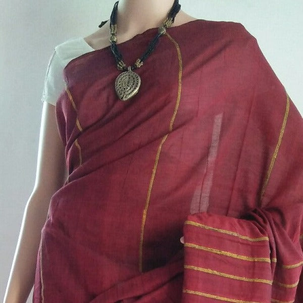 maroon khesh saree draped over a mannequin