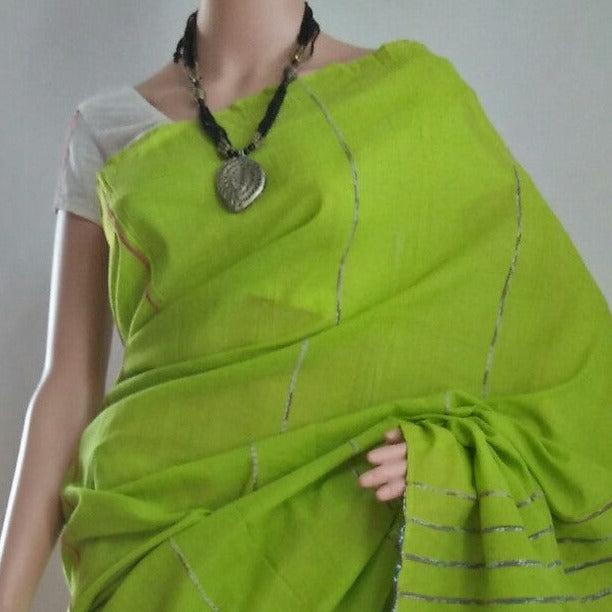 lime green khesh saree draped over a mannequin